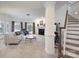 Inviting living room featuring fireplace, staircase, neutral carpet, large windows, and French doors to the outside at 1915 Cavendale Dr, Rock Hill, SC 29732