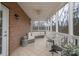 Cozy screened porch featuring a comfortable sectional sofa and a ceiling fan for warm days at 1915 Cavendale Dr, Rock Hill, SC 29732