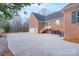 Spacious driveway and exterior side of the brick home with a view of the garage and a small porch at 1915 Cavendale Dr, Rock Hill, SC 29732