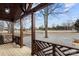 Covered front porch with wooden railing overlooking the street at 19601 S Ferry St, Cornelius, NC 28031