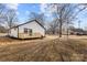 White house with gray roof, wooden deck, and backyard view at 19601 S Ferry St, Cornelius, NC 28031