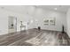 Spacious living room with vaulted ceiling and grey wood flooring at 19601 S Ferry St, Cornelius, NC 28031