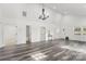 Spacious living area showcasing hardwood floors and access to bedrooms and bath at 19601 S Ferry St, Cornelius, NC 28031