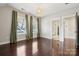 Bright bedroom featuring dark hardwood floors and green curtains at 2043 Shenandoah Ave, Charlotte, NC 28205