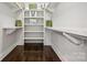 Large walk-in closet with built-in shelving and hanging rods at 2043 Shenandoah Ave, Charlotte, NC 28205