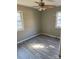 Bedroom with gray walls, wood-look flooring, and ceiling fan at 2505 Druid Hills Way, Charlotte, NC 28206