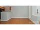 Simple dining area with hardwood floors and adjacent kitchen at 2514 Cranbrook Ln # 5, Charlotte, NC 28207