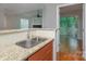 Kitchen with granite countertops, double sink, and access to balcony at 2514 Cranbrook Ln # 5, Charlotte, NC 28207