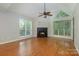 Bright living room with hardwood floors, fireplace, and vaulted ceiling at 2514 Cranbrook Ln # 5, Charlotte, NC 28207