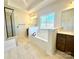 Elegant bathroom with soaking tub, double vanity, and walk-in shower at 2558 Red Hill Nw St # 51, Concord, NC 28027