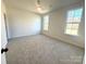 Bright bedroom with neutral carpeting and two large windows at 2558 Red Hill Nw St # 51, Concord, NC 28027