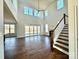 Two-story living room with hardwood floors, fireplace, and sliding doors at 2558 Red Hill Nw St # 51, Concord, NC 28027