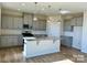 Island kitchen with gray cabinets and granite countertops at 2632 Tillman St, Monroe, NC 28112