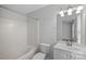 Clean bathroom with tub, toilet, and white vanity at 3026 Uxbridge Woods Ct, Charlotte, NC 28205