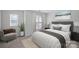 Bedroom with neutral decor, large window, and plush bedding at 3026 Uxbridge Woods Ct, Charlotte, NC 28205