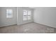 Bright bedroom with neutral carpeting and two large windows at 3026 Uxbridge Woods Ct, Charlotte, NC 28205