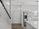 Bright entryway with hardwood floors, white door, and staircase at 3026 Uxbridge Woods Ct, Charlotte, NC 28205