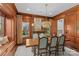 Formal dining room with wood paneling, chandelier, and built-in window seat at 303 Hillside Ave, Charlotte, NC 28209