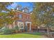 Brick home with a three-story design, dormers, and landscaping at 303 Hillside Ave, Charlotte, NC 28209