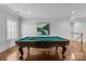 Game room with a large pool table and hardwood floors at 303 Hillside Ave, Charlotte, NC 28209