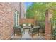 Private brick patio with seating area and greenery at 303 Hillside Ave, Charlotte, NC 28209