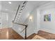 Stunning wooden staircase with hardwood floors and white railings at 303 Hillside Ave, Charlotte, NC 28209