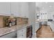 Kitchen wet bar with granite countertop, wine cooler, and glass storage at 303 Hillside Ave, Charlotte, NC 28209