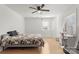 Bedroom with hardwood floors, ceiling fan, and built-in desk at 303 S Greene St, Wadesboro, NC 28170