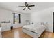 Bright bedroom with hardwood floors and ceiling fan at 303 S Greene St, Wadesboro, NC 28170