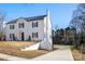 White brick home with a long driveway and partial view of the backyard at 303 S Greene St, Wadesboro, NC 28170