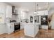 Spacious kitchen featuring white cabinets, a large island, and stainless steel appliances at 303 S Greene St, Wadesboro, NC 28170