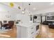 Open concept kitchen and dining area with white island and hardwood floors at 303 S Greene St, Wadesboro, NC 28170