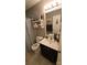 Clean bathroom with single vanity, shower, and updated toilet at 306 Bluegill Ln, Statesville, NC 28625