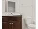 Bathroom with dark brown vanity and white toilet at 3148 Ora Smith Rd, Lincolnton, NC 28092