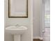 Small powder room with pedestal sink and mirror at 3148 Ora Smith Rd, Lincolnton, NC 28092