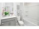 Bathroom with a shower-tub combination, white toilet, and vanity with gray cabinetry at 3148 Ora Smith Rd, Lincolnton, NC 28092