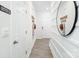 Hallway with white trim and plank flooring, featuring hooks and a round mirror at 3148 Ora Smith Rd, Lincolnton, NC 28092