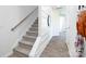 A modern staircase with carpeted steps, a wooden handrail, and a view into an adjacent hallway at 3148 Ora Smith Rd, Lincolnton, NC 28092