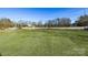 Open backyard with a grassy area and distant homes at 335 Pinewood Ln, Rock Hill, SC 29730