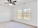 Bright bedroom with neutral carpeting, ceiling fan, and large windows offering natural light at 335 Pinewood Ln, Rock Hill, SC 29730