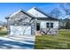 New construction home with stone and white siding, two-car garage, and landscaped lawn at 335 Pinewood Ln, Rock Hill, SC 29730