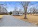 Inviting home with gravel driveway, well-manicured lawn, and classic architectural design at 368 Luther Scronce Rd, Vale, NC 28168