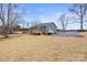 View of home with a small porch and rear entry, surrounded by a spacious yard with mature trees at 368 Luther Scronce Rd, Vale, NC 28168