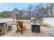 Backyard patio with fire pit and built-in grill at 3836 Lake Breeze Dr, Sherrills Ford, NC 28673