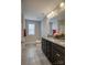 Clean bathroom with dark brown vanity, granite countertop and tiled floors at 3836 Lake Breeze Dr, Sherrills Ford, NC 28673