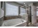 Main bathroom with soaking tub, shower, and updated fixtures at 3836 Lake Breeze Dr, Sherrills Ford, NC 28673