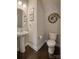 Clean powder room with pedestal sink and dark hardwood floors at 3836 Lake Breeze Dr, Sherrills Ford, NC 28673