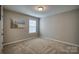 Simple bedroom with neutral walls, carpet, and window with blinds at 3836 Lake Breeze Dr, Sherrills Ford, NC 28673