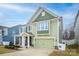 Green two-story house with a two-car garage and front porch at 3836 Lake Breeze Dr, Sherrills Ford, NC 28673