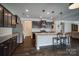 Kitchen with an island, dark cabinets, and white backsplash at 3836 Lake Breeze Dr, Sherrills Ford, NC 28673